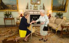 The new leader of the Conservative Party Theresa May (L) kneels as she is greeted by Britain's Queen Elizabeth II (R) at the start of an audience in Buckingham Palace in central London on July 13, 2016 where the Queen invited the former Home Secretary to become Prime Minister and form a new government. Theresa May became Britain's second female prime minister on July 13 charged with guiding the UK out of the European Union after a deeply devisive referendum campaign ended with Britain voting to leave and David Cameron resigning. Picture: AFP.