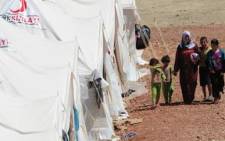 Syrian refugees walk at the Turkish Red Crescent's second camp in the Yayladagi district of Hatay, two kilometres from the Syrian border, on June 19, 2011. Picture: AFP