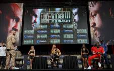 Broadcaster Kate Abdo (C) moderates a news conference for WBC heavyweight champion Tyson Fury (L) and Deontay Wilder (2nd R) at MGM Grand Garden Arena on 6 October 2021 in Las Vegas, Nevada. Picture: Ethan Miller/AFP