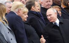 Russian President Vladimir Putin (R), talks with German Chancellor Angela Merkel (C) and US President Donald Trump as they attend a ceremony at the Arc de Triomphe in Paris on 11 November 2018 as part of commemorations marking the 100th anniversary of the 11 November 1918 armistice, ending World War I. Picture: AFP