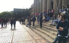 Students outside Wits University Great Hall look on as police move to restore calm after stun grenades were fired when some students refused to be moved away on 4 October 2016. Picture: Clement Manyathela/EWN.