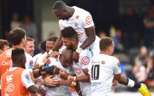 The Sharks' Madosh Tambwe (top) with teammates Hyron Andrews (centre R), Makazole Mapimpi (C) and Curwin Bosch (R) celebrate a try during the Super Rugby match against the Highlanders at the Forsyth Barr Stadium in Dunedin on 7 February 2020. Picture: AFP