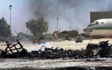 FILE:A picture taken on 16 July 2014, shows the remains of a burnt airplane at the Tripoli international airport in the Libyan capital. Picture: AFP.