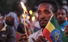 A man holds a candle during a memorial service for the victims of the Tigray conflict organised by the city administration, in Addis Ababa, Ethiopia, on 3 November 2021. Picture: EDUARDO SOTERAS/AFP