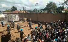 FILE: This frame grab taken from video footage shows crowds as they confront UN peacekeepers in a UN compound on the outskirts of the eastern DRC town of Beni on 25 November 2019. Protesters stormed the camp angered by failures to curb a notorious armed group that killed eight civilians overnight.