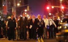 New York Police Commissioner James O'Neill (center right) and Mayor Bill de Blasio (center left) walk into a press conference as police, firefighters and emergency workers gather at the scene of an explosion in Manhattan on 17 September 2016 in New York City. Picture: Getty Images/AFP.