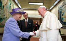 Britain's Queen Elizabeth (L), accompanied by her husband the Duke of Edinburgh Prince Philip (C), as she greets Pope Francis at the Vatican on 3 April. Picture: AFP.