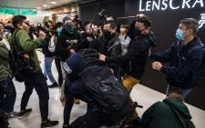 Plainclothes police officers (with batons) clash with pro-democracy protesters during a rally inside a shopping mall in Sheung Shui in Hong Kong on 28 December 2019. Hong Kong has been battered by more than six months of protests that has upended the financial hub's reputation for stability and helped tip the city into recession. Picture: AFP.
