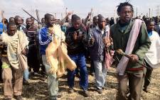 Protesters from Lonmin's Marikana Mine carry traditional weapons as they protest for better salaries. Picture: Taurai Maduna/EWN.