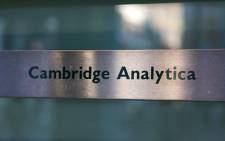FILE: A Cambridge Analytica sign is pictured at the entrance of the building which houses the offices of Cambridge Analytica, in central London on 21 March 2018. Picture: AFP.