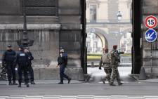 French police officers and soldiers patrol in front of the Louvre museum on February 3, 2017 in Paris after a soldier has shot and gravely injured a man who tried to attack him. Picture: AFP