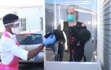 Healthcare workers at a Western Cape facility test a coronavirus testing booth donated by the Arm in Arm in Africa organisation. Picture: Supplied