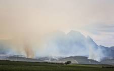 Columns of smoke rise from the Cape winelands outside Stellenbosch on the morning of 22 January 2016 as firefighters and farm owners face a third day of battling the Simonsberg fire. Picture: Aletta Harrison/EWN