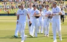 England's James Anderson (L) walks from the field with teammate Stuart Broad (R) and other team members after their win during day four of the first cricket Test match between New Zealand and England at Bay Oval in Mount Maunganui on 19 February 2023. Picture: Marty MELVILLE/AFP