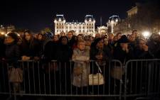 FILE. People gather outside Notre Dame cathedral in Paris on 15 November 2015 during mass in homage victims two days after a series of deadly attacks. Picture: AFP.
