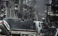 Smoke billows from a building where Islamic State (IS) group fighters are taking shelter as Iraqi forces fight them, in the Old City of Mosul on 3 July, 2017. Picture: AFP