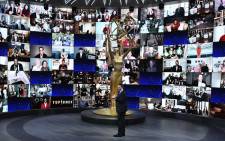 This handout picture released courtesy of Image Group LA/ American Broadcasting Companies, Inc./ ABC shows shows host Jimmy Kimmel in front of a wall of nominees watching remotely at the Staples Center during the 72nd Primetime Emmy Awards ceremony held virtually on 20 September 2020. Picture: AFP