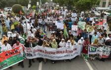 Activists of the ruling Pakistan Tehreek-e-Insaf (PTI) party take part in an anti-India protest march in Lahore on 5 August 2019, in reaction to the move by India to abolish Kashmir's special status. Picture: AFP