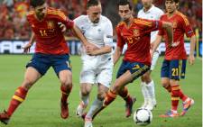 FILE: Spanish midfielder Xabi Alonso (L) and Spanish defender Alvaro Arbeloa (R) tackle French midfielder Franck Ribery during the Euro 2012 football championships quarter-final match Spain vs France on June 23, 2012 at the Donbass Arena in Donetsk. Picture: AFP