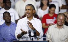 Florida Democratic gubernatorial nominee Andrew Gillum, and Senator Bill Nelson listen to former President Barack Obama as he addresses the media and supporters as they stump for votes at a rally in Miami, Florida 2 November, 2018. Picture: AFP.