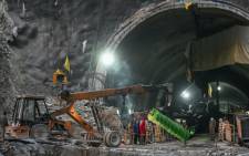 A crane carries a part of drilling machine as rescue operation enters its final phase, for workers trapped in the Silkyara under construction road tunnel, days after it collapsed in the Uttarkashi district of India's Uttarakhand state on 22 November 2023. Picture: Arun SANKAR/AFP