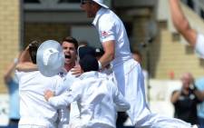 England's James Anderson (C) celebrates with teammates after taking the final wicket of Brad Haddin for 71 during play on the fifth day of the first Ashes cricket test match between England and Australia at Trent Bridge in Nottingham, central England on 14 July, 2013. England won the test by 14 runs and take a 1-0 lead in the best of five series. Picture:AFP