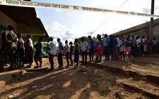 People queue to vote in the general elections on 7 March at a polling station in Freetown. More than 3.1 million voters are registered for the polls across the small West African nation. Picture: AFP.