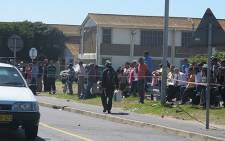 FILE: People watch on following a shooting in Lavender Hill. Picture: Shamiela Fisher/EWN