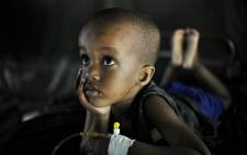 FILE: Mohammed, suffering from Malaria, recovers at a clinic. Picture: United Nations Photo.