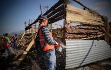 FILE: The eviction unit uses chainsaws and crowbars to demolish shacks. Picture: Thomas Holder/EWN.