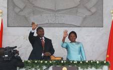 Sworn in Angolan President Joao Lourenco (L) and his wife Ana Dias de Lourenco wave to the crowd at the end of his swearing in ceremony as the new Angolan President on 26 September 2017 in Luanda. Picture:  AFP