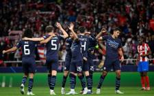 Manchester City players celebrate at the end of the Uefa Champions League quarterfinal second leg football match between Club Atletico de Madrid and Manchester City FC at the Wanda Metropolitano stadium in Madrid on 13 April 2022. Picture: Pierre-Philippe MARCOU/AFP