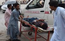 A victim of a bomb blast is brought to a hospital in Quetta on 13 July, 2018 following an attack at an election rally. Picture: AFP