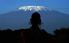 A Maasai man is silhouetted in front of Mount Kilimanjaro in Kimani on December 13, 2014. Picture: AFP