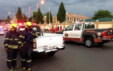 Emergency services officials wait outside Radovan Krejcir’s Money Point shop in Bedfordview where an explosion occurred on 12 November 2013. Picture: Mandy Wiener/EWN.