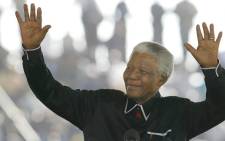 FILE: Former South African President Nelson Mandela pays tribute to his life-long friend and ANC colleague Walter Sisulu, at the apartheid struggle hero's funeral in Soweto 17 May 2003. Picture: AFP.