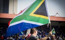 A man waves the South African flag at the Freedom Movement rally against the leadership of President Jacob Zuma in Pretoria on 27 April 2017. Picture: Reinart Toerien/EWN