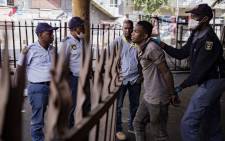 Police make an arrest in Hillbrow, Johannesburg during day one of the coronavirus lockdown on 27 March 2020. Picture: Sethembiso Zulu/EWN