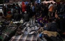 A group of Central American migrants, mostly from Honduras, moving towards the United States, rest near El Chaparral port of entry at the US-Mexico border after a demonstration as Federal Police guards in Tijuana, Baja California state, Mexico, on 22 November 2018. Picture: AFP