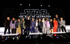 (L-R) Richard E. Grant, Billy Dee Williams, Keri Russell, Oscar Isaac, Adam Driver, Writer/director J.J. Abrams, Co-writer Chris Terrio, Producer and President of Lucasfilm Kathleen Kennedy, Daisy Ridley, John Boyega, Kelly Marie Tran, Naomi Ackie, Joonas Suotamo and Anthony Daniels participate in the global press conference for 'Star Wars: The Rise of Skywalker' at the Pasadena Convention Center on 4 December 2019 in Pasadena, California. Picture: AFP.
