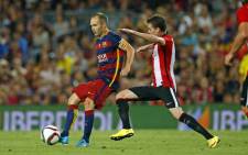 Barcelona's Andres Iniesta is marked by Athletico Bilbao player during their Spanish Super Cup final on 17 August 2015. Picture: Barcelona/Facebook.