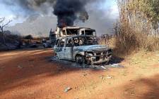 This handout image from the Karenni Nationalities Defense Force (KNDF) taken and released on 25 December 2021 shows burnt vehicles in Hpruso township in Kayah state. Picture: Handout/KARENNI NATIONALITIES DEFENSE FORCE (KNDF)/AFP