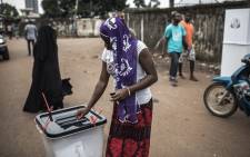 FILE: A voter casts her ballot at a voting booth in the popular opposition neighbourhood of Bambeto during presidential elections in Conakry, Guinea on 18 October 2020. Picture: AFP