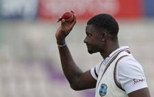 West Indies' Jason Holder leaves the field with the ball after taking six wickets to help bowl out England for 204 runs in the first innings on the second day of the first Test cricket match between England and the West Indies at the Ageas Bowl in Southampton, southwest England on 9 July 2020. Picture: AFP