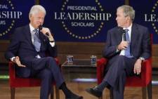 Former US President George W Bush looks on as former president Bill Clinton answers a question at the Presidential Leadership Scholars graduation ceremony at the George W Bush Institute on 13 July, 2017 in Dallas, Texas. Picture: AFP.