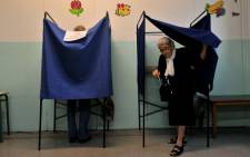 An elderly woman leaves the voting booth in a polling station in Thessaloniki, on 20 September, 2015. Picture: AFP.