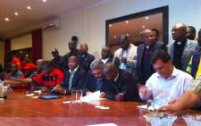 Lonmin officials and union members signing a wage agreement reached on 18 September 2012. Picture: Gia Nicolaides/EWN.