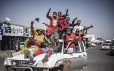 Supporters of Zambian President elect for the opposition party United Party for National Development (UPND) Hakainde Hichilema gestures as they ride on a pick up truck in the streets of Lusaka on August 16, 2021. Picture: Marco Longari / AFP.