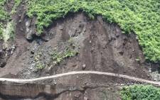 FILE: A landslide aftermath is pictured along a damaged road. Picture: AFP.