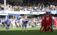 Liverpool players celebrate after getting their third goal during the English Premier League football match between Queens Park Rangers and Liverpool at Loftus Road in London on October 19, 2014. Picture: AFP